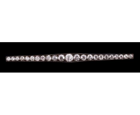 An early 20th century diamond bar brooch, the graduated old cut diamonds in a tapered millegrained setting, approximately 2.7