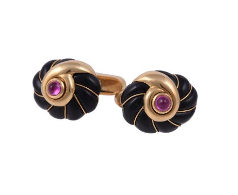 A pair of ruby and onyx cufflinks by William & Son, the coiled carved onyx panels with gold wire accents, each centred with a
