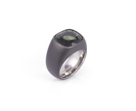 A green tourmaline ring by Hemmerle, the cushion cut green tourmaline in an oxidised iron setting, the shank signed Hemmerle 