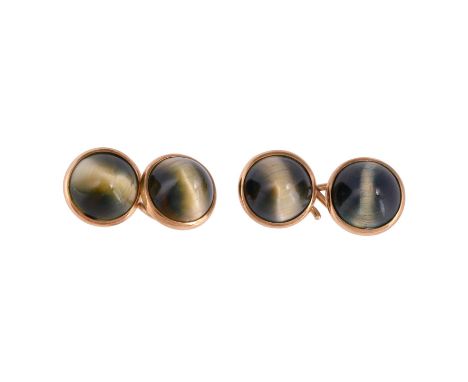 A pair of late Victorian hawks eye cufflinks, circa 1900, the circular sugarloaf cabochon hawks eye panels within gold settin