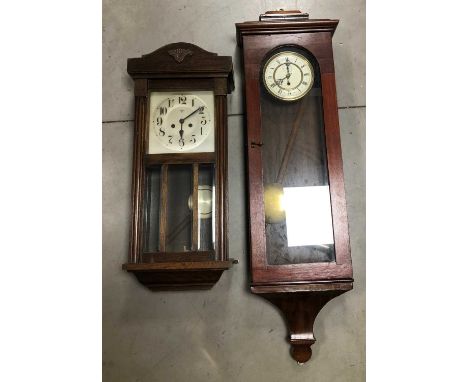 Two 20th century wooden cased wall mounted clocks, the dials with Romand Arabic numerals, the largest 120cm in length, togeth