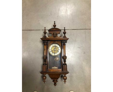 A 20th century Vienna wall clock,  wooden case, mounted and surmounted, the dial with finials, Roman Numerals, untested, 73cm