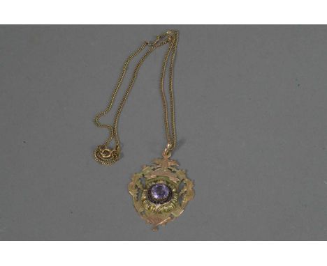 A Victorian 9ct. gold presentation Masonic medallion, with central claw set amethyst, within an enamel garter with Latin insc