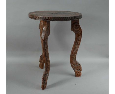 A small carved hardwood Indian tripod table, a Buddha carved to the top, carved shaped supports, 50.5cm H x 38cm W