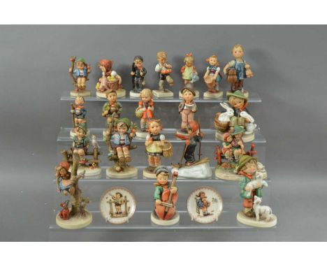 A large collection of Hummel ceramic figures, of differing sizes and styles, including two small dishes, all marked to the un