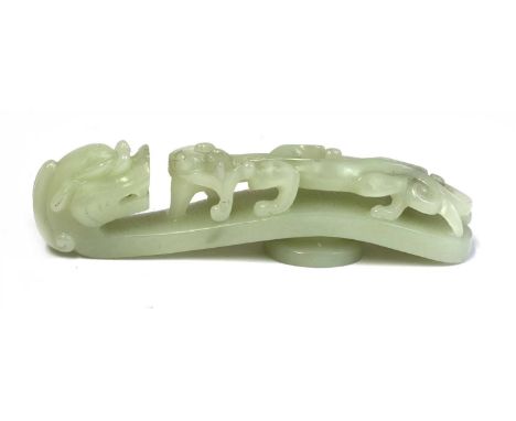 A Chinese jade belt hook, of typical form, one end with a dragon's head, the other with a chilong climbing up the body, the s