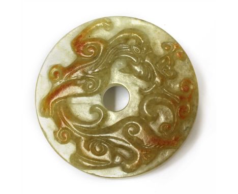 A Chinese jade bi disc, of circular form, carved with a dragon in relief, the reverse with scrolls, 5.4cm diameter