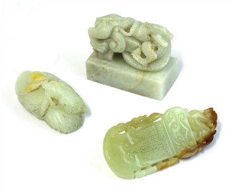 A collection of three Chinese jade carvings, comprising: a seal with a dragon finial on a cylindrical plinth, 6.2cm long, a j