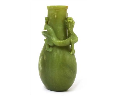 A Chinese jade vase, the compressed pear-shaped body carved with a dragon chasing a flaming pearl encircling the neck, the st