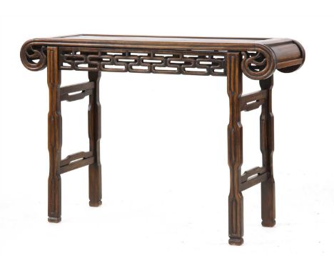 A Chinese scroll table, 19th century, the rectangular top with a ruyi head-shaped frieze above a key fret apron, on four legs