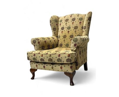 Georgian design wingback armchair, upholstered in tapestry-style fabric with topiary tree motifs, shaped wings and padded arm