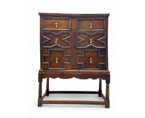 18th century oak chest on stand, moulded cornice over two short and two long drawers with applied geometric mouldings, on tur