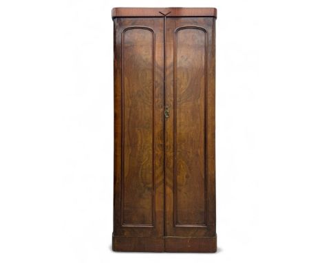 Victorian figured walnut single wardrobe, the moulded cornice with a central diamond motif over a pair of arched panelled doo