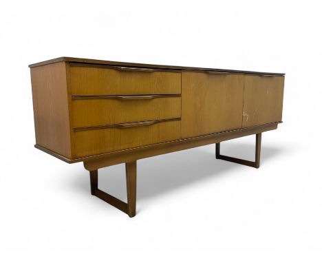 Mid-20th century teak sideboard, three drawers with integrated handles to the left, central fall-front compartment opening to