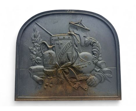 French cast iron fireback, arched form with relief of medieval armour and heraldic symbols, including a shield with a cross a