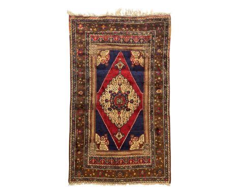 Persian crimson and navy ground rug, the central diamond medallion with floral detailing, flanked by navy spandrels with styl