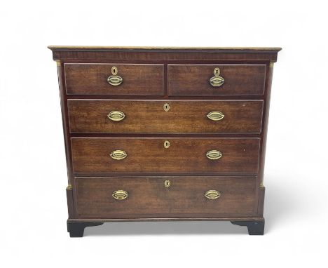 George III oak chest, fitted with two short and three long drawers, black painted top with gilt edge, oval pressed brass hand