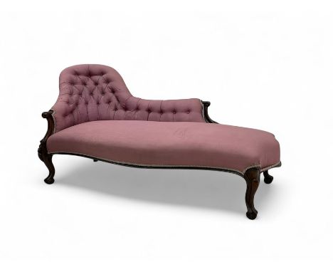 Victorian mahogany framed chaise longue, button-tufted backrest with scrolled headrest, upholstered in moiré-patterned pink f