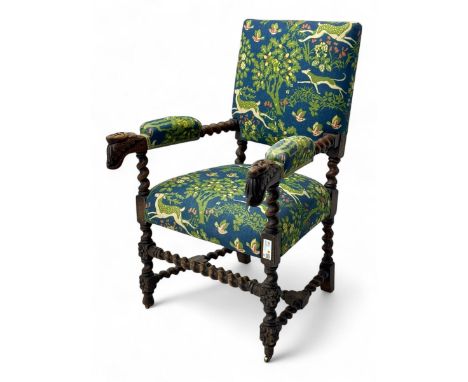 19th century Carolean design oak armchair, upholstered in a vibrant fabric depicting woodland and wildlife scenes, carved lio