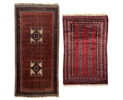 Persian Bokhara crimson ground rug with repeating Tekke gul motifs and stylised tree branches (181cm x 121cm), Baluch rust-re