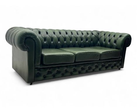 Three seat Chesterfield design sofa, upholstered in emerald green leather with deep-buttoned detailing, rolled arms, and thre