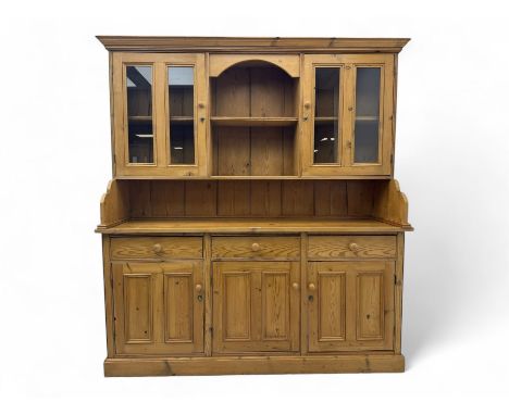 Large pine dresser, raised display cabinets over three drawers and three panelled cupboards, on plinth baseDimensions: Height