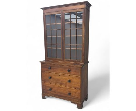 Late 19th century mahogany bookcase on chest, projecting moulded cornice over twin astragal glazed doors enclosing three shel