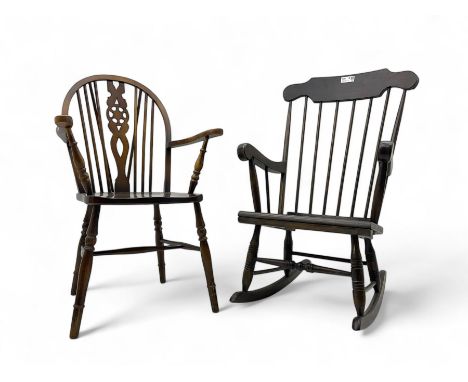 Early 20th century Windsor design rocking chair, shaped cresting rail over a spindle back, curved arms and plain seat, raised