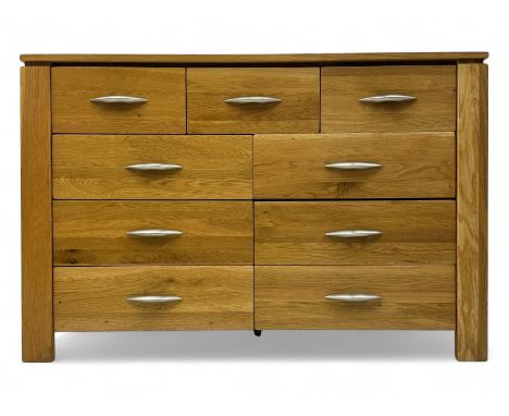 Contemporary light oak sideboard, rectangular top over three short and six long drawers each fitted with chrome handles, on p