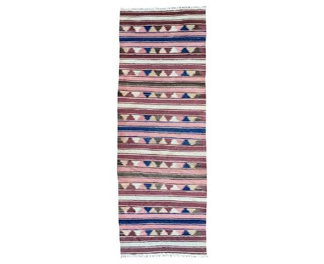 Kilim muted pink ground runner, decorated with rows of horizontal bands in muted tones, alternating with geometric triangular