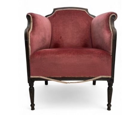 Late Victorian walnut framed tub-shaped armchair, the moulded frame decorated with flower head roundels, upholstered in pink 