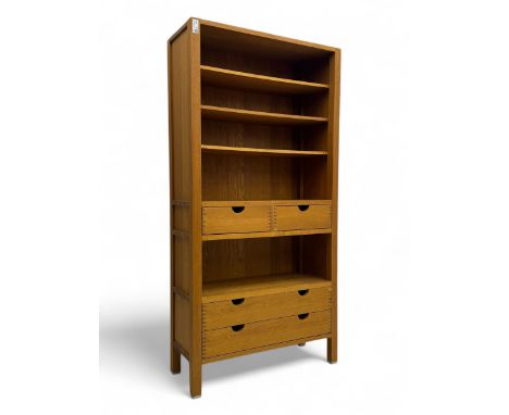 Contemporary oak bookcase, rectangular form fitted with three open shelves over two short and two long drawers with cut-out h