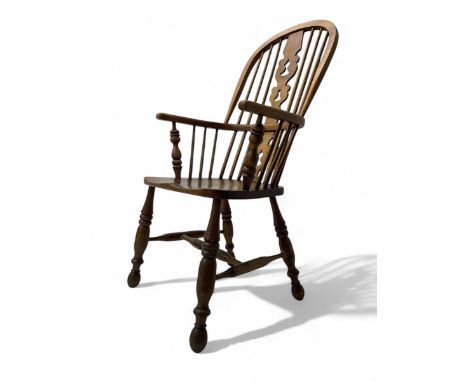 19th century elm Windsor armchair, high hoop back with central pierced splat over shaped saddle seat, raised on turned suppor