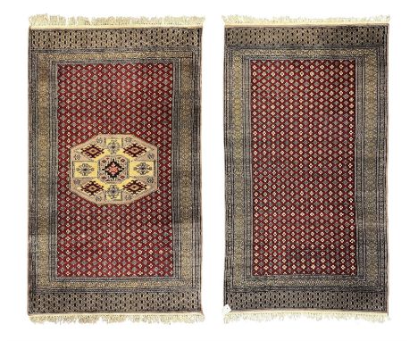 Pakistani Kashan hand-knotted rug with a central medallion and intricate geometric floral patterns, set against a red field a