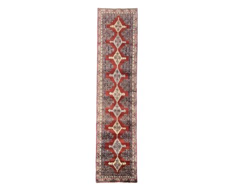 Northwest Persian Senneh crimson ground runner, central medallion design with geometric motifs extending through the field, f