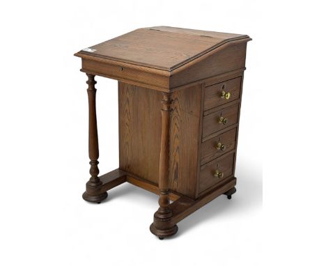 19th century pitch pine Davenport desk, sloping hinged top, fitted with four drawers, on turned column supports, turned compr