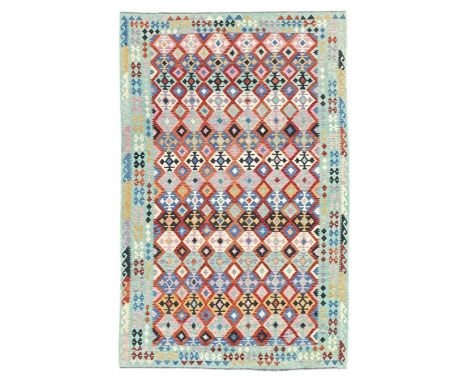 Kilim pastel ground rug, the field decorated with repeating multicoloured geometric diamond motifs, enclosed within matching 