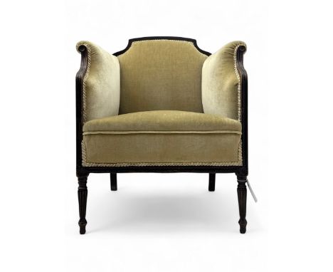 Early 20th century mahogany framed armchair, upholstered in fawn fabric with braid trim, on turned reeded supportsDimensions: