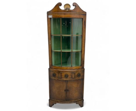 Georgian design mahogany bow-front corner display cabinet, scroll-carved neck pediment crowned by shell motif, astragal glaze