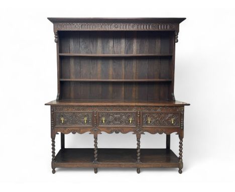 Late 19th century carved oak dresser, the two-tier plate rack with projecting moulded cornice over arcade and flower head car