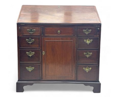 George III mahogany bureau, the fall-front enclosing fitted interior with pigeonholes and central cupboard, over an arrangeme