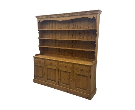 Large traditional pine dresser, shaped cornice over three open shelves, base fitted with four drawers above four panelled cup