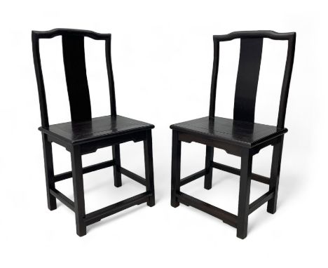 Pair of early 19th century Chinese Qing dynasty black wood side chairs, yoke cresting rail over shaped back panel, panelled r