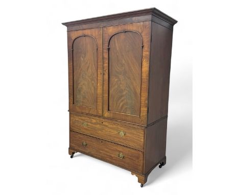 Early Victorian mahogany linen press, projecting moulded cornice over twin arched panelled doors with applied mouldings, encl