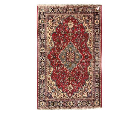 Central Persian Isfahan crimson ground carpet, central floral medallion in ivory and blue, set within a field of dense floral