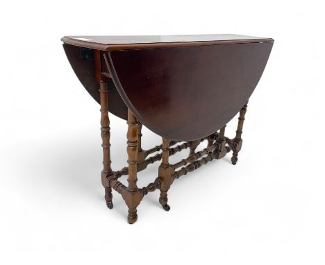 19th century mahogany drop leaf dining table, circular top over turned gateleg supports terminating in ceramic castorsDimensi