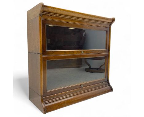 Early 20th century oak stacking barrister's bookcase, moulded cornice over two glazed compartments each with lift-and-slide d