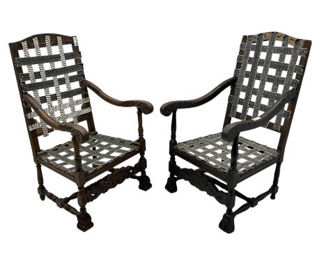 Two Carolean design open armchair frames, one in beech and the other in oak, high arched back over down sweeping arms carved 