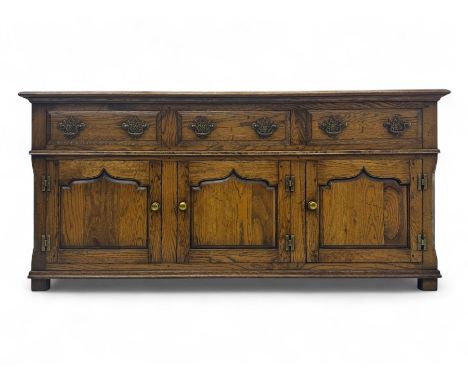 Early 20th century Jacobean design oak dresser base, rectangular top with moulded edge over three baize-lined drawers with pi