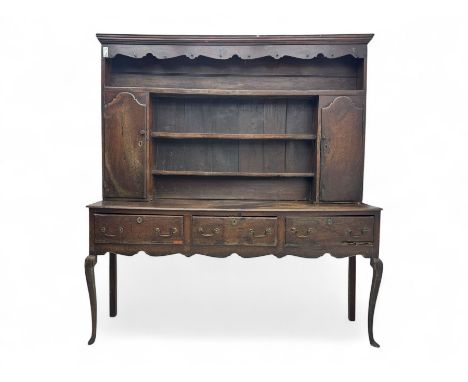 Georgian oak dresser, moulded cornice with shaped pediment over three tiers and two cupboards, the base fitted with three dra